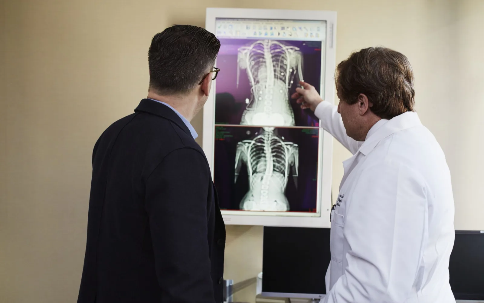 Doctor explaining a spine X-ray to a patient