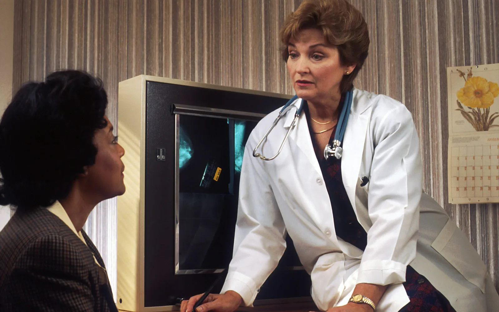 Woman doctor talking through breast imaging results with a patient