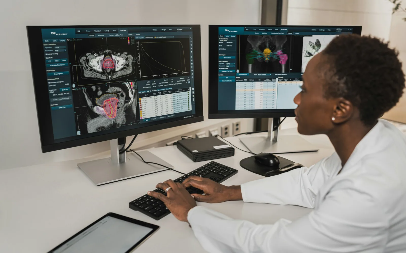 Radiologist reviewing scans on reporting monitors
